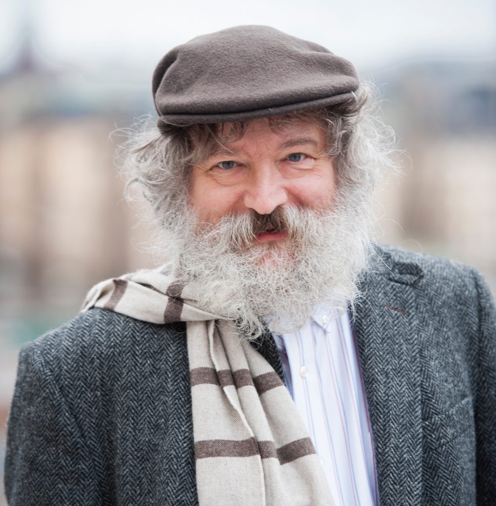Bearded man in flat cap smiling