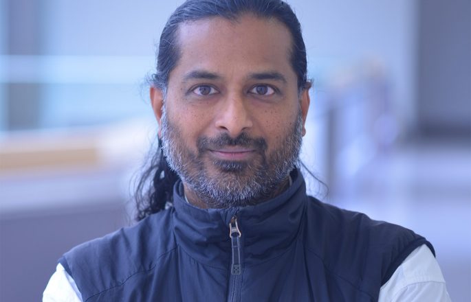 Professor standing in lab space