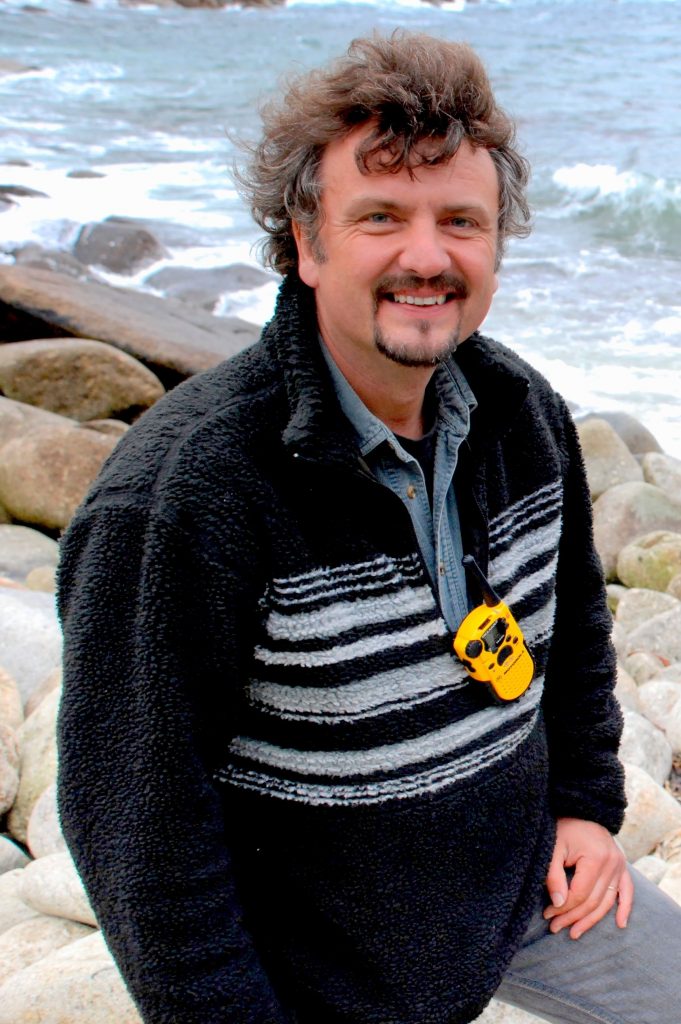 Man smiling on coast - Prof Simon Haslett