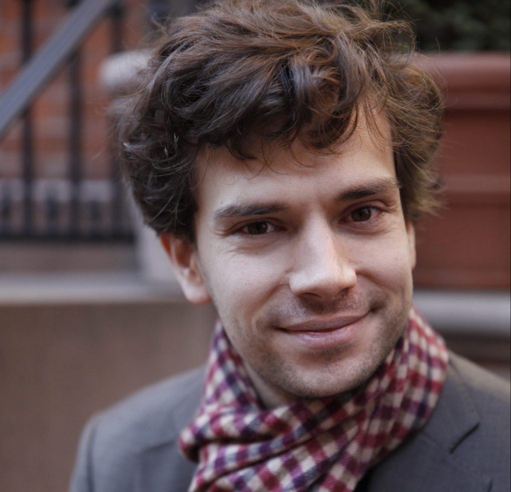 Professor Jean Baccelli, Tutorial Fellow in Philosophy, man with brown hair smiling, wearing a patterned scarf