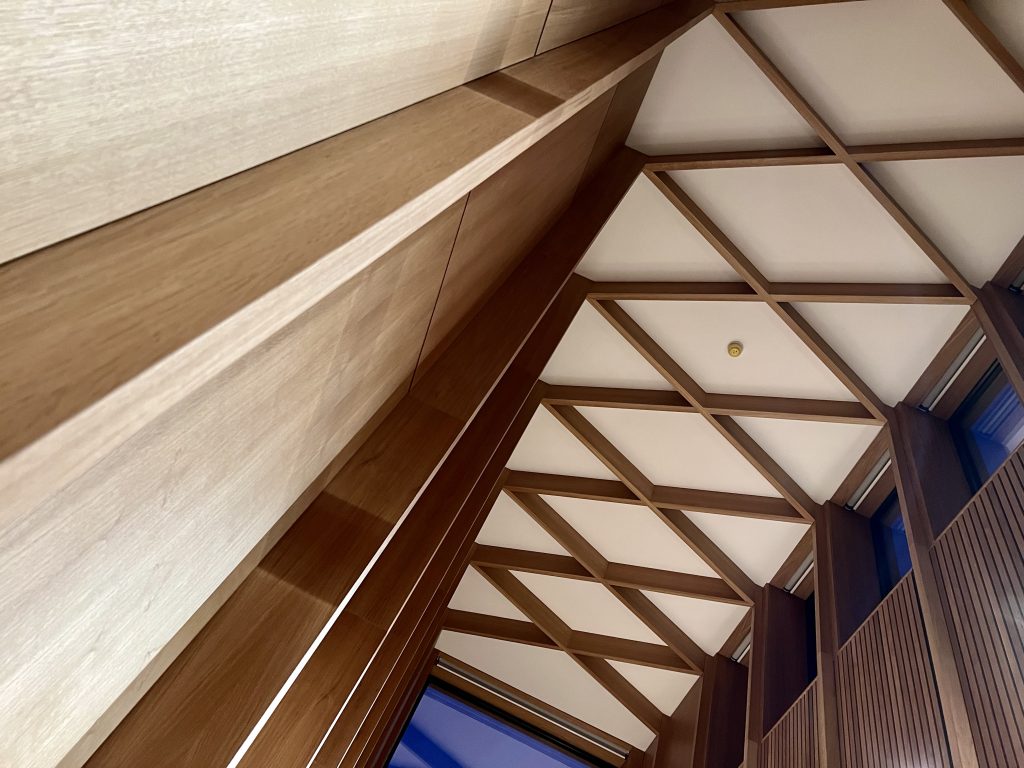 View looking up of oak panelling and corniced ceiling.